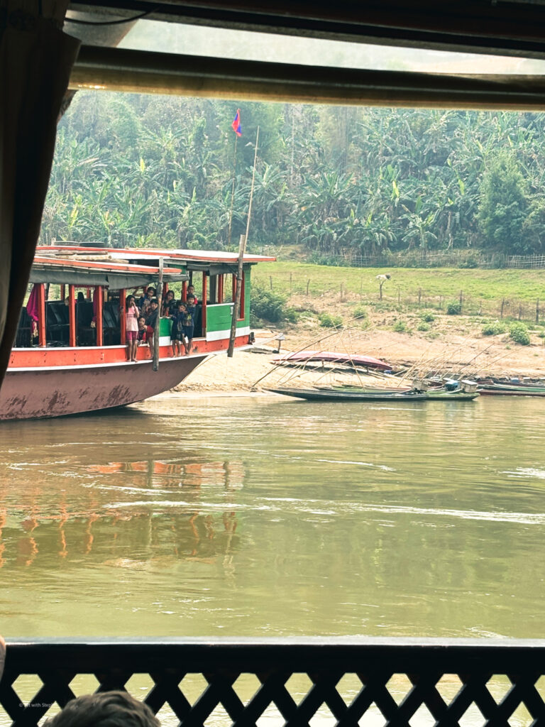 Children waiting for the slow boat to arrive in Laos 