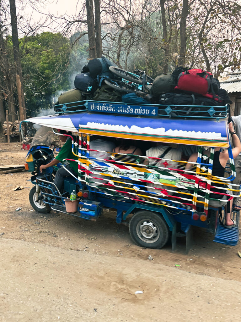 An overcrowded tuktuk taking passengers from the slow boat arrival point in Luang Prabang to the city centre