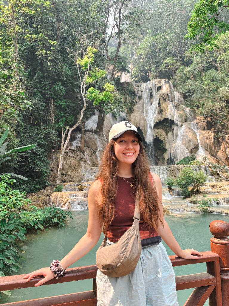 Jet with Steph smiling in front of Kuang Si waterfall in Laos