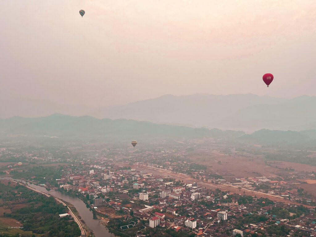 Hot air balloons floating over Vang Vieng in Laos 